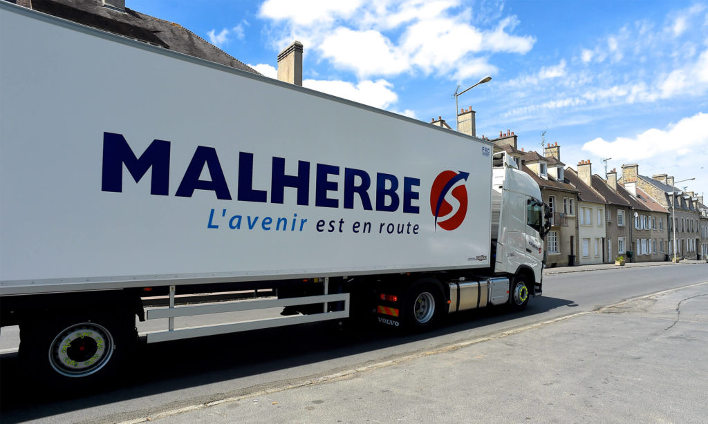 Camion Malherbe roulant dans une petite ville